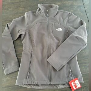 Brand new (with tags) women’s North Face fleece-lined charcoal gray jacket
